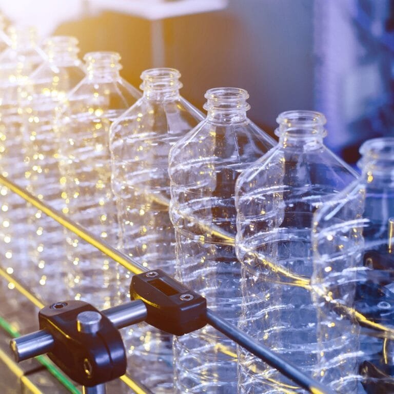 Illustration showing the step-by-step recycling process of PET bottles into recycled polyester fibers for sustainable industries.